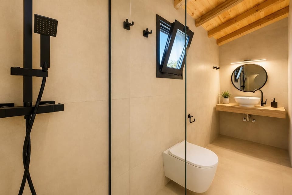 Stylish double bedroom with air conditioning, warm natural wood furnishings, soft lighting, and contemporary Mediterranean decor.