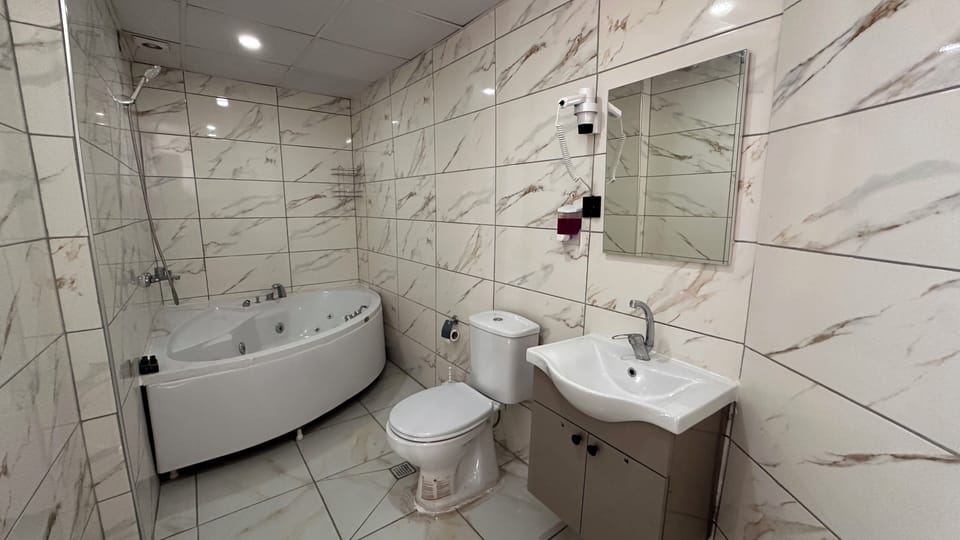 Deluxe Suite, City View | Bathroom | Shower, hair dryer, towels, soap