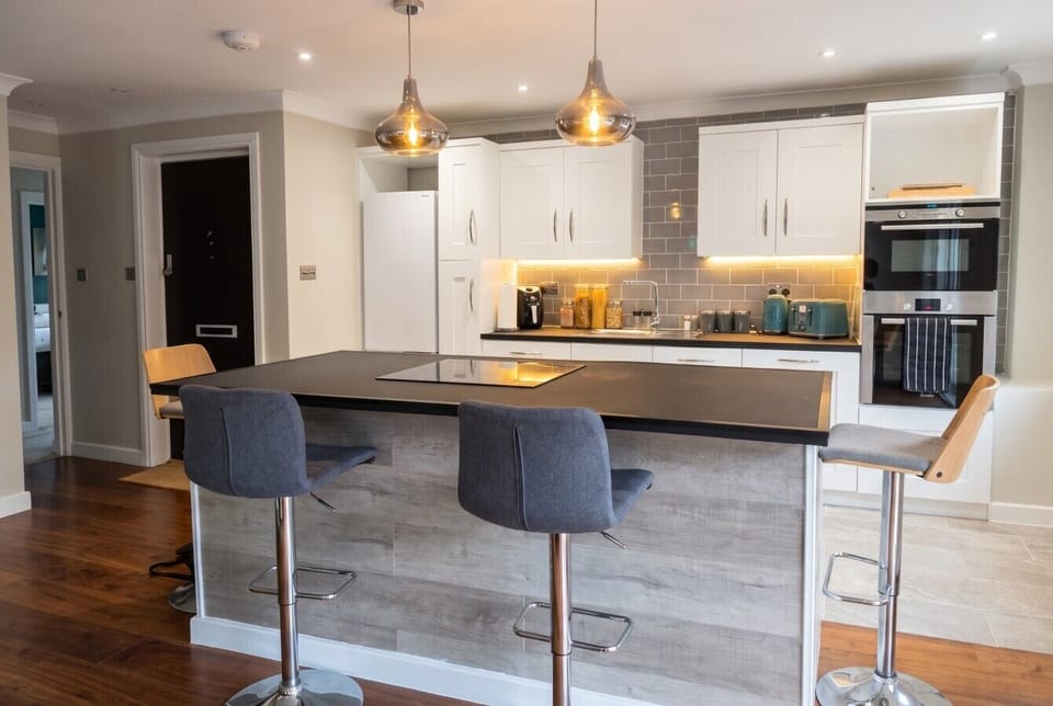 Modern kitchen with breakfast bar seating and every appliance you need