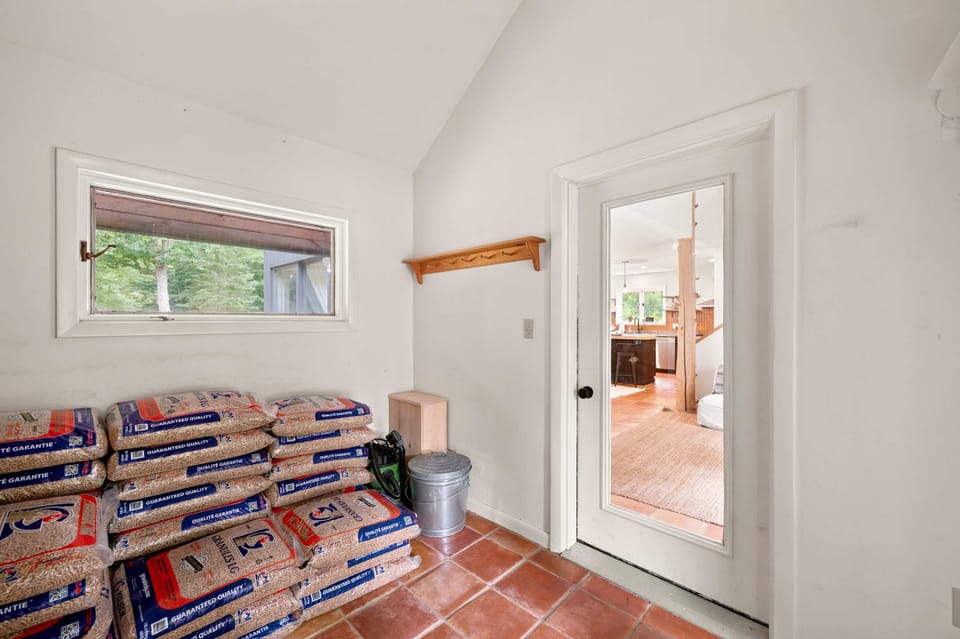 Step in through the private foyer, where terracotta tile and a doorway lead into the home from the garage.