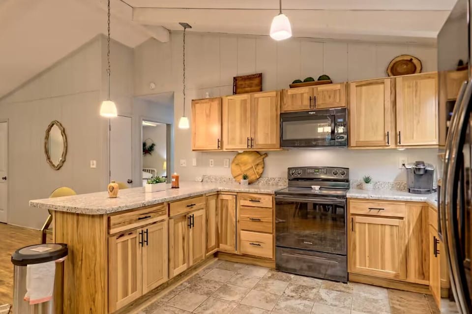 Bright modern kitchen with warm wood cabinets and spacious peninsula