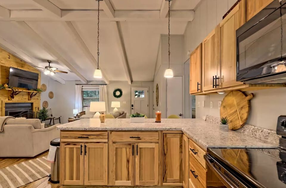 Open-concept kitchen with granite counters and cozy fireplace lounge