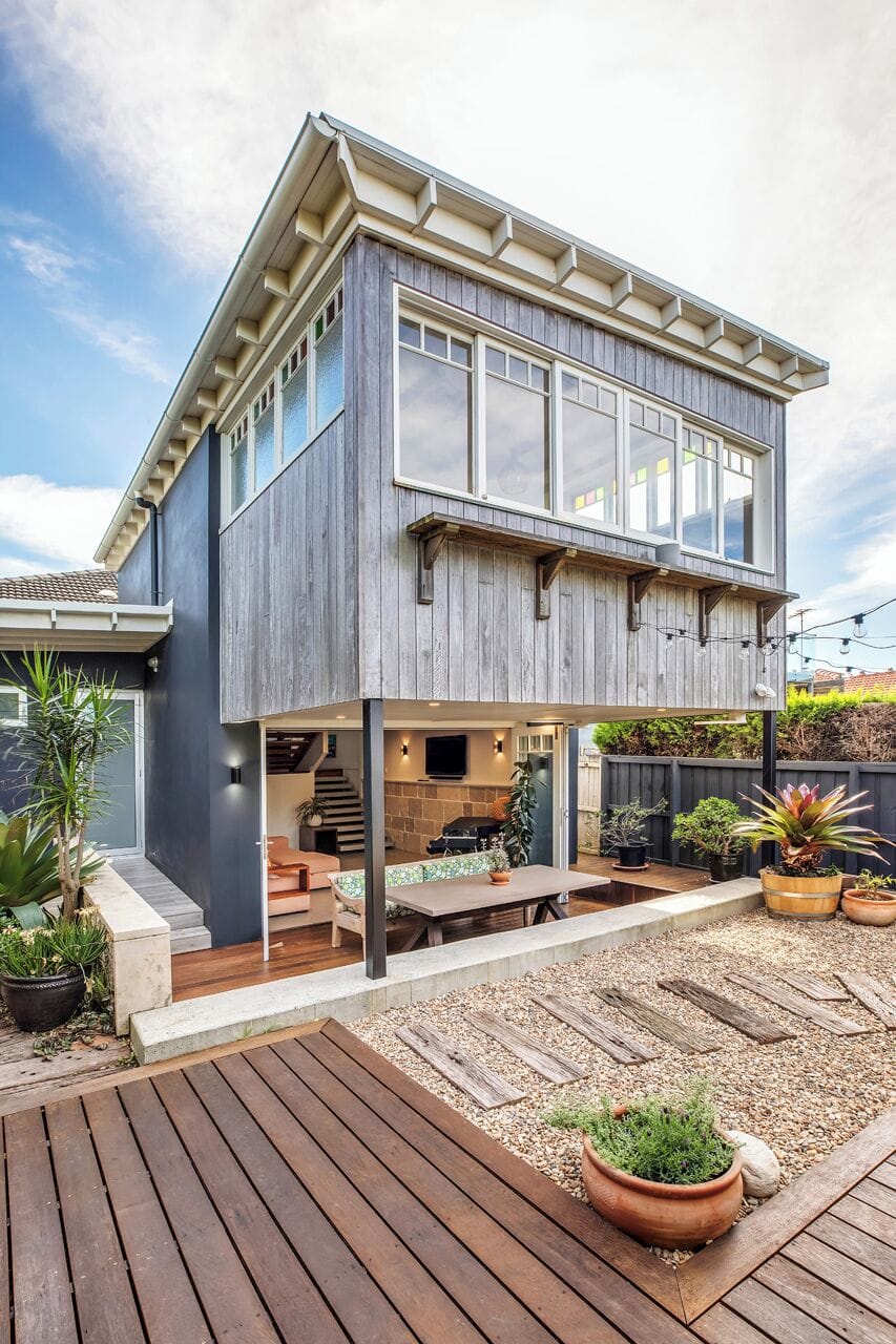 The rear of the home showcases its unique split-level architecture, revealing how generous indoor living spaces connect beautifully with the private outdoor entertaining areas.