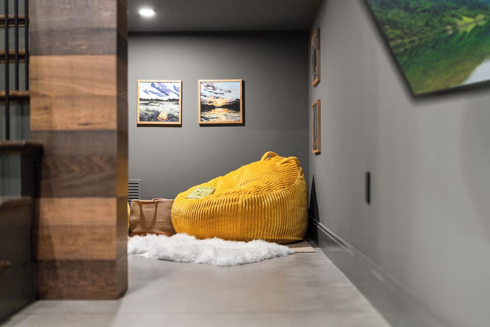 Cozy reading nook with oversized bean bag and modern moody style