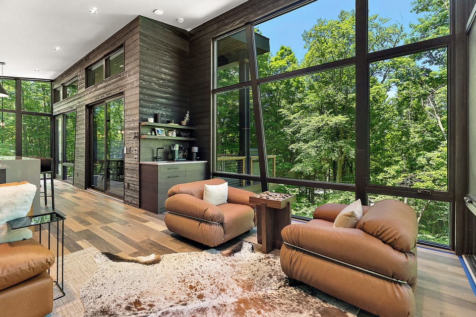 Soaring windows, forest views, and a stylish modern lounge area