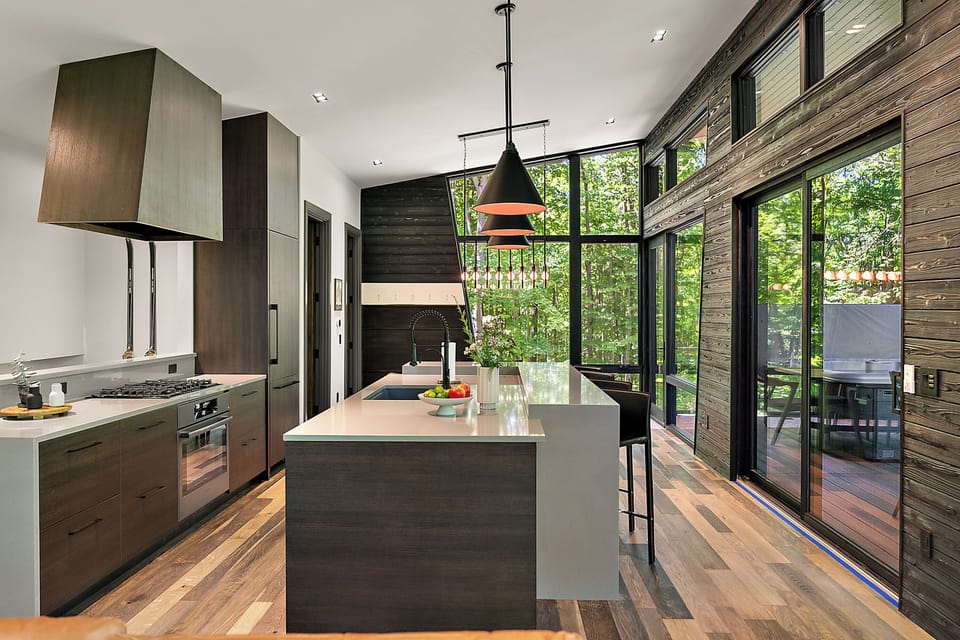 Designer kitchen with soaring windows and seamless indoor-outdoor flow