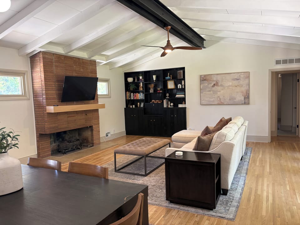 Spacious living room with vaulted ceilings, fireplace, and cozy seating