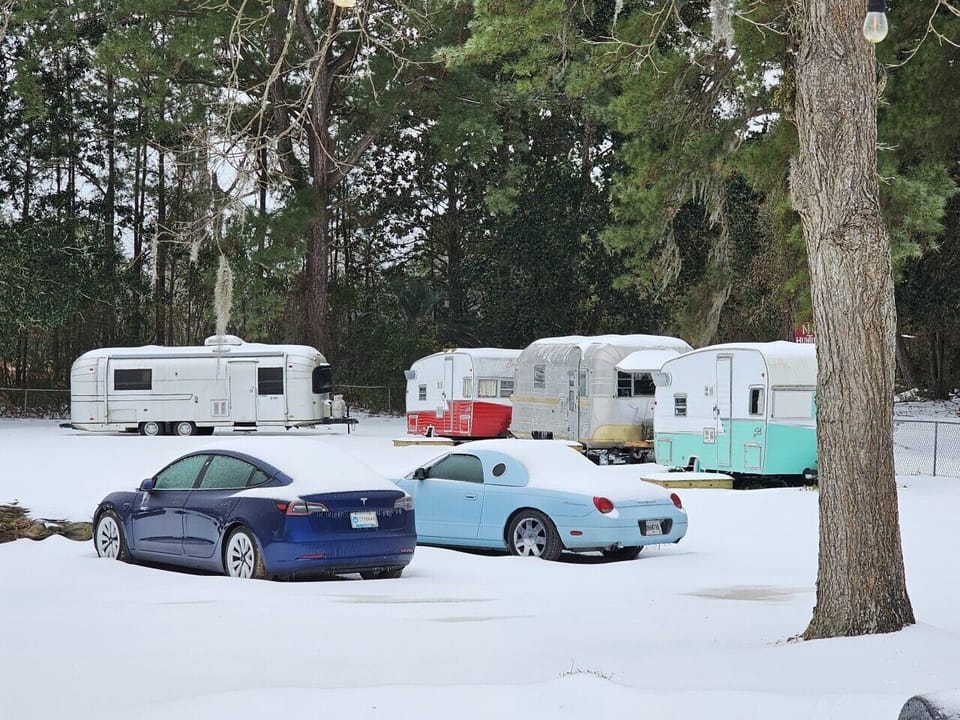 Retro meets the future. A classic Thunderbird, a Tesla, and our vintage campers blanketed in one of Georgia`s rarest snowfalls. At Mid Way Retro Retreat, every season has its own kind of magic. ❄️