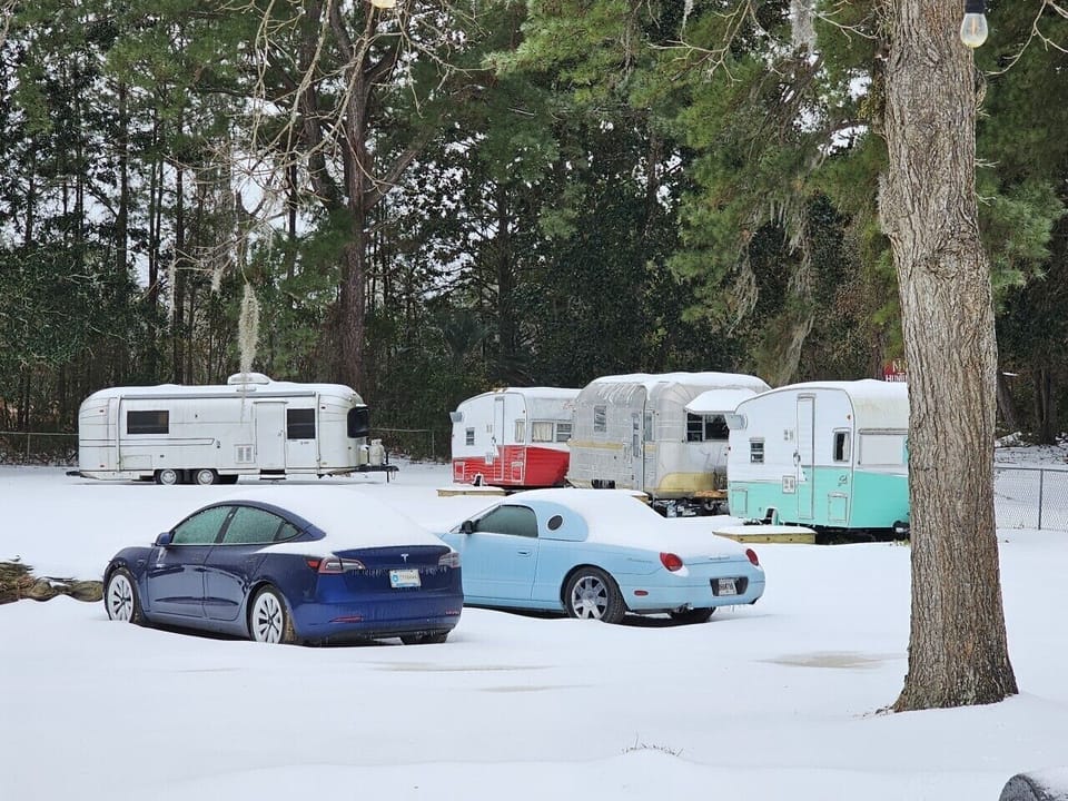 Retro meets the future. A classic Thunderbird, a Tesla, and our vintage campers blanketed in one of Georgia`s rarest snowfalls. At Mid Way Retro Retreat, every season has its own kind of magic. ❄️