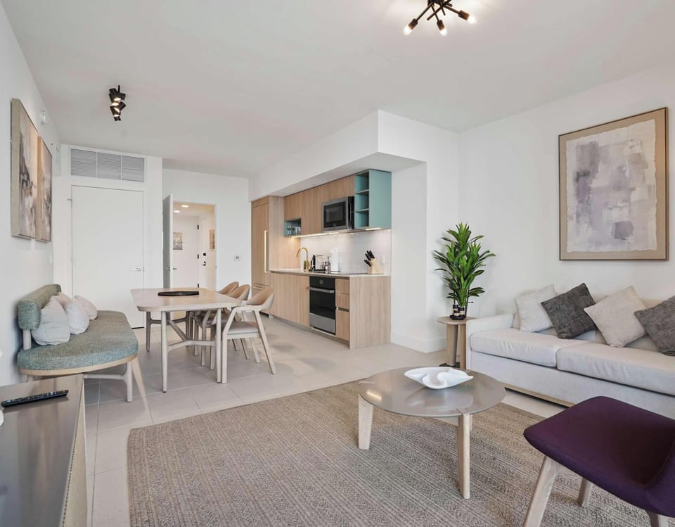 Open living area with comfortable seating and a modern kitchen.