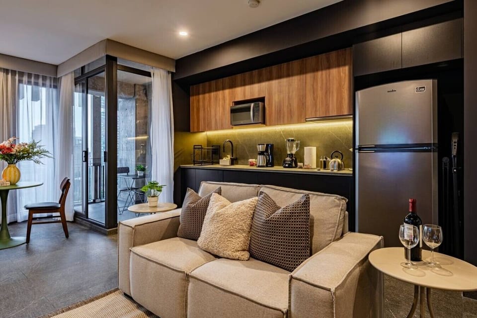 Living area with comfortable seating and a fully equipped kitchen.