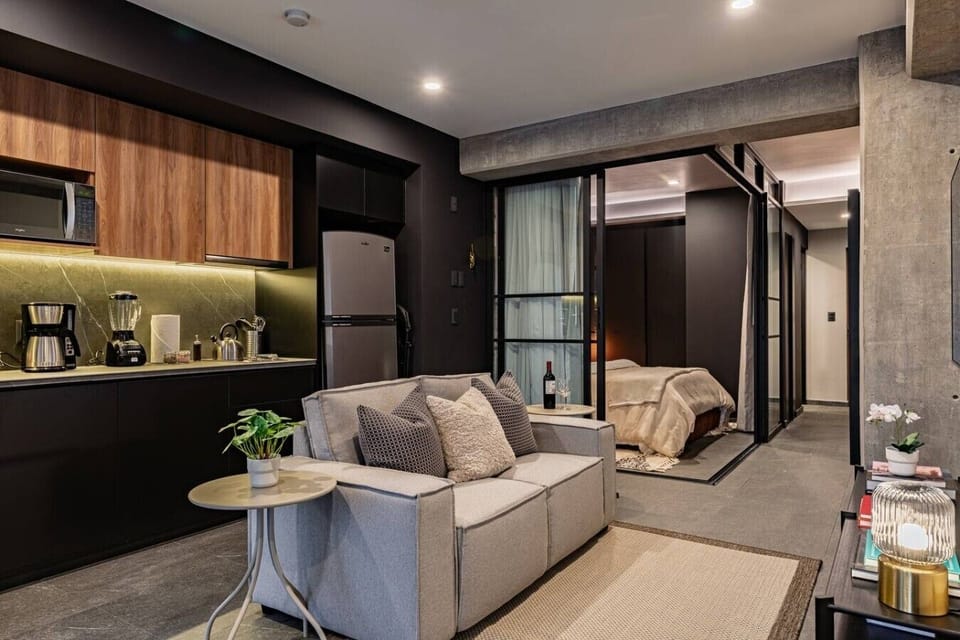 Open-concept living space with a sofa and glass-panel doors.