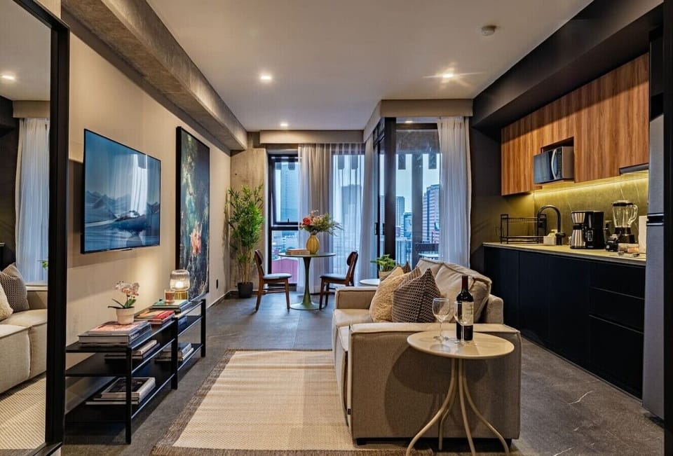 A stylish open-concept living space with a fully equipped kitchen.