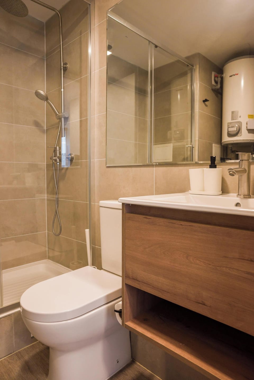 Modern bathroom with sleek fixtures and a spacious shower, perfect for a refreshing start to your day.