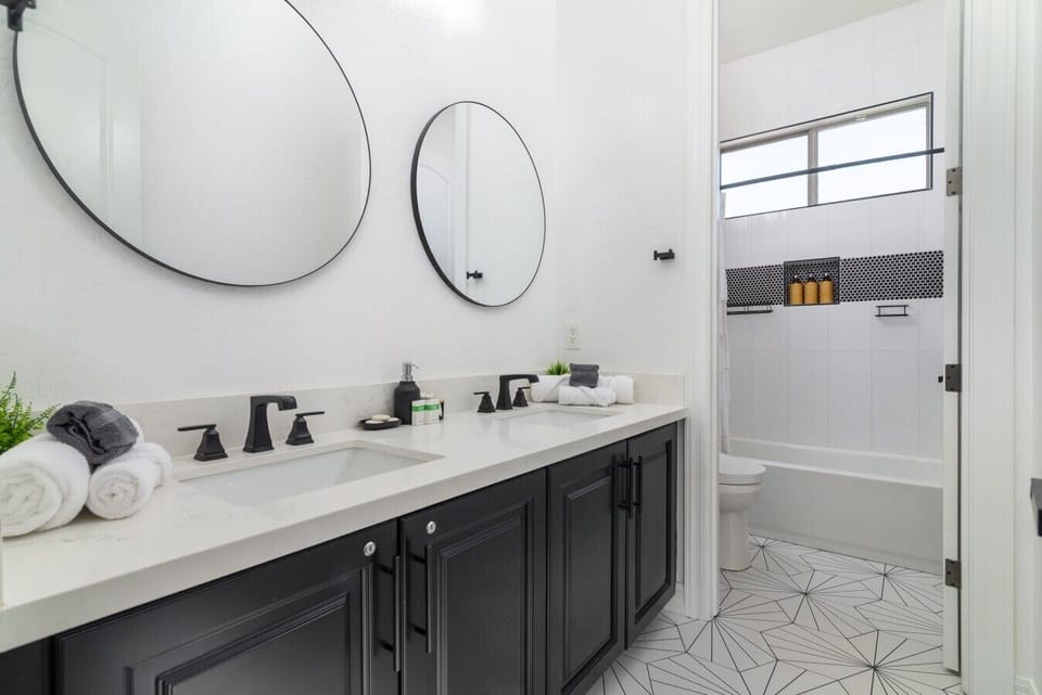 Beautifully appointed shared bathroom with double sinks and a spacious shower/tub combination—perfect for families or groups getting ready for the day`s adventures.