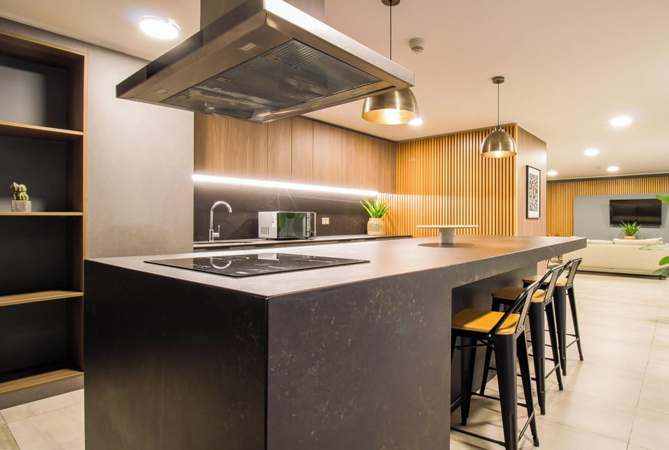 Stylish open kitchen with waterfall island and chic lounge area