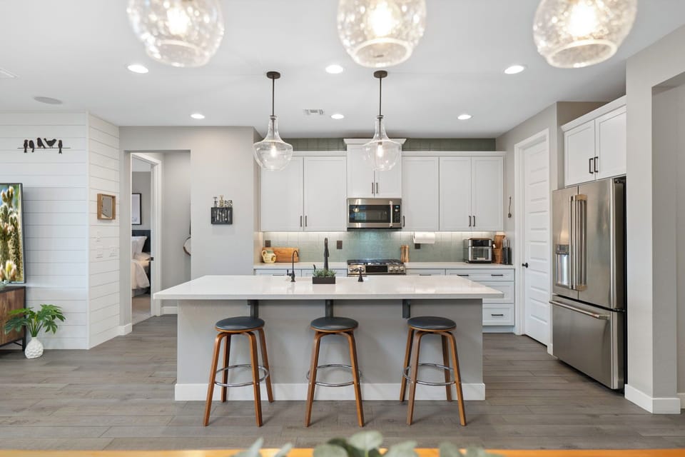 There are three barstools at the kitchen island.