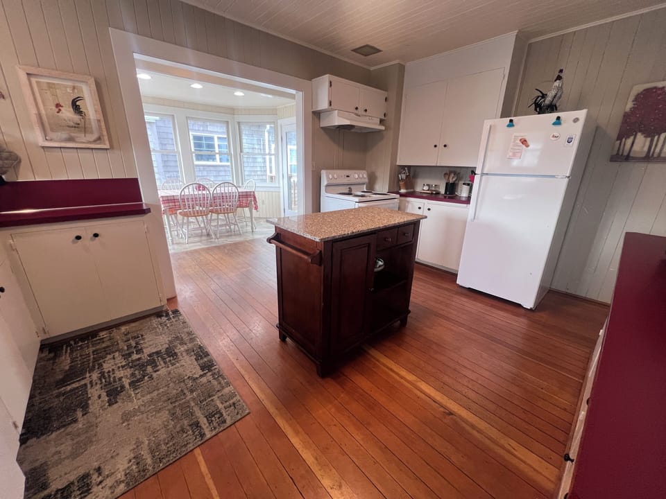 Step into your charming kitchen, antique cabinetry, and a cozy window seat that invites you to relax with morning coffee.