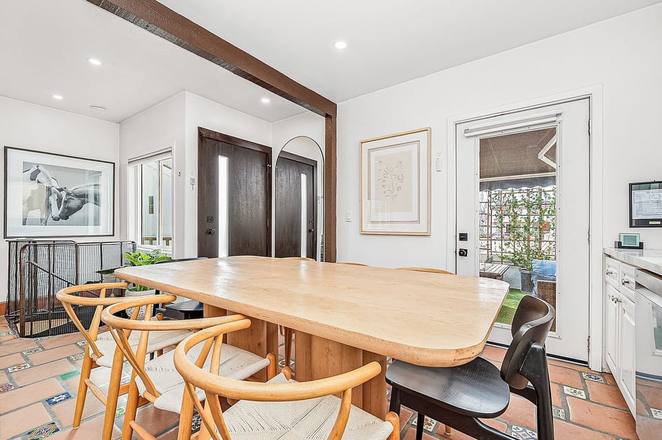 Share meals around the spacious dining table nestled in the kitchen
                