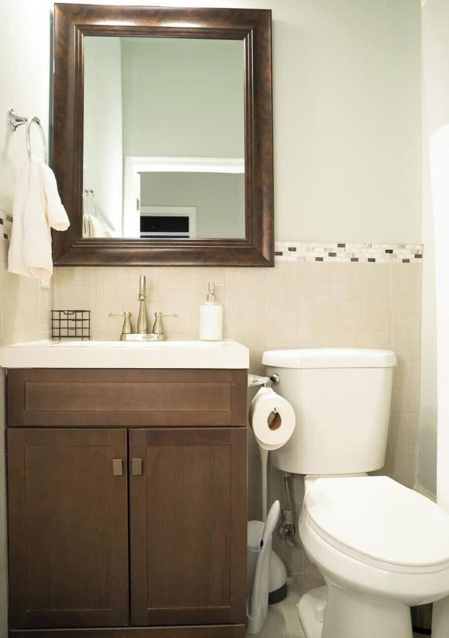 Sparkling clean full bathroom stocked with fresh towels and essential toiletries.