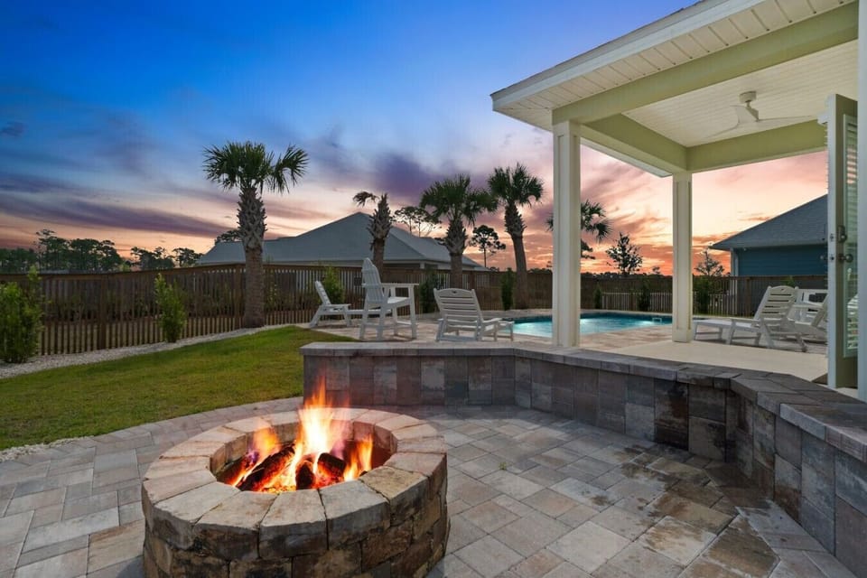 Firepit by the pool with seating bench