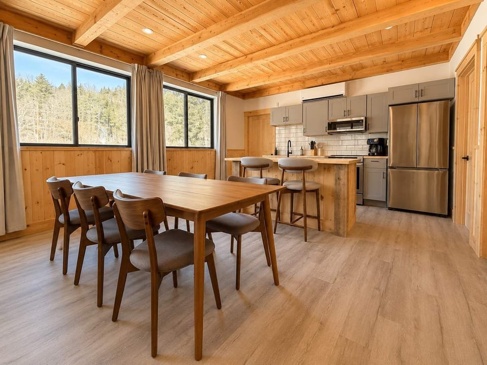 Dining Area: Gather in a bright kitchen and dining area with modern appliances, ample counter space, and a comfortable table for sharing meals, coffee, and conversation.