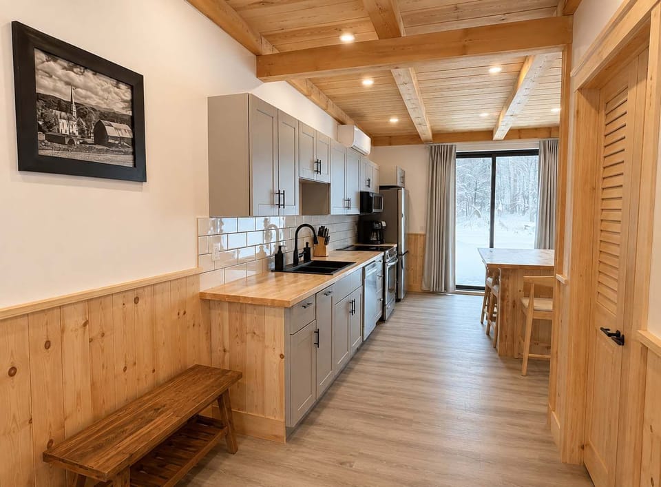 Kitchen: Gather in a bright kitchen and dining area with modern appliances, ample counter space, and a comfortable table for sharing meals, coffee, and conversation.