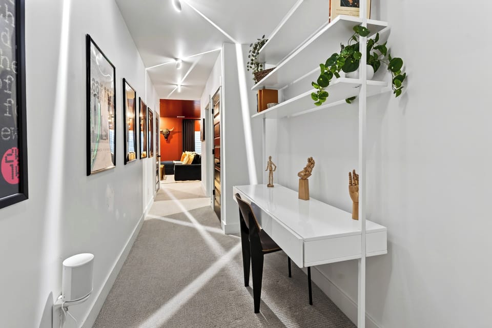 right hallway workstation featuring a minimalist built-in desk and shelving.