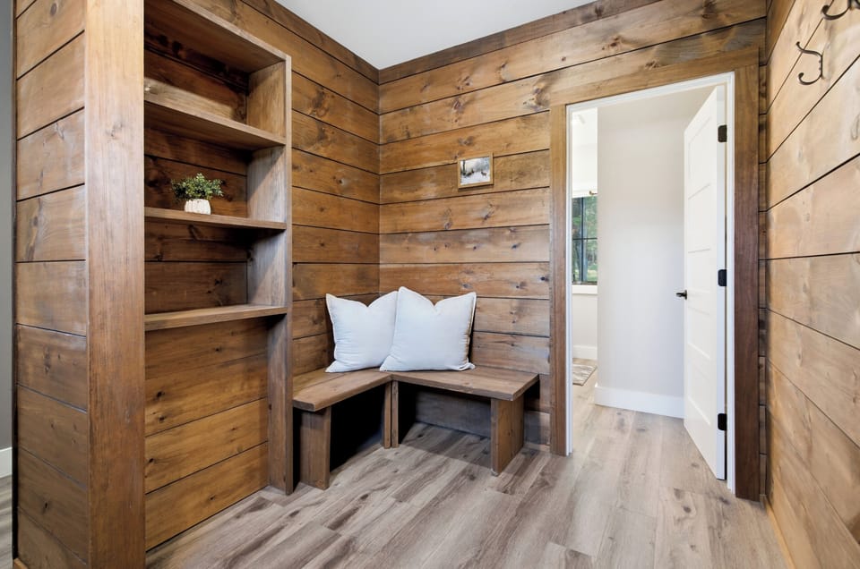 Rustic wood finishes and built-in seating bring warmth and character to the home.