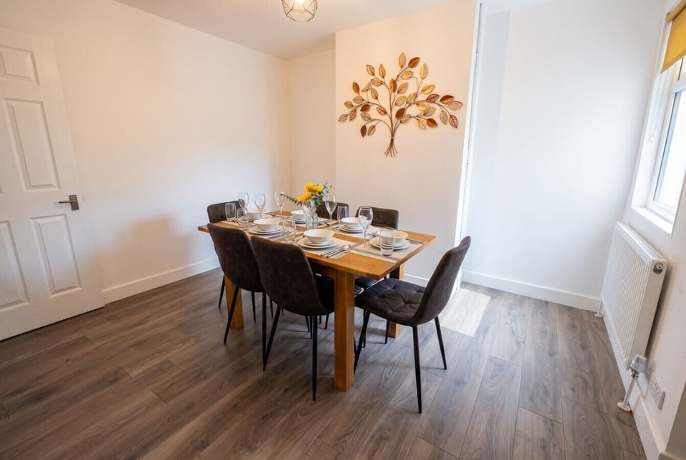 Gather around the dining table set for six under soft natural light.