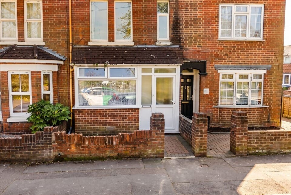Classic red-brick terrace with easy street access and a welcoming entrance.