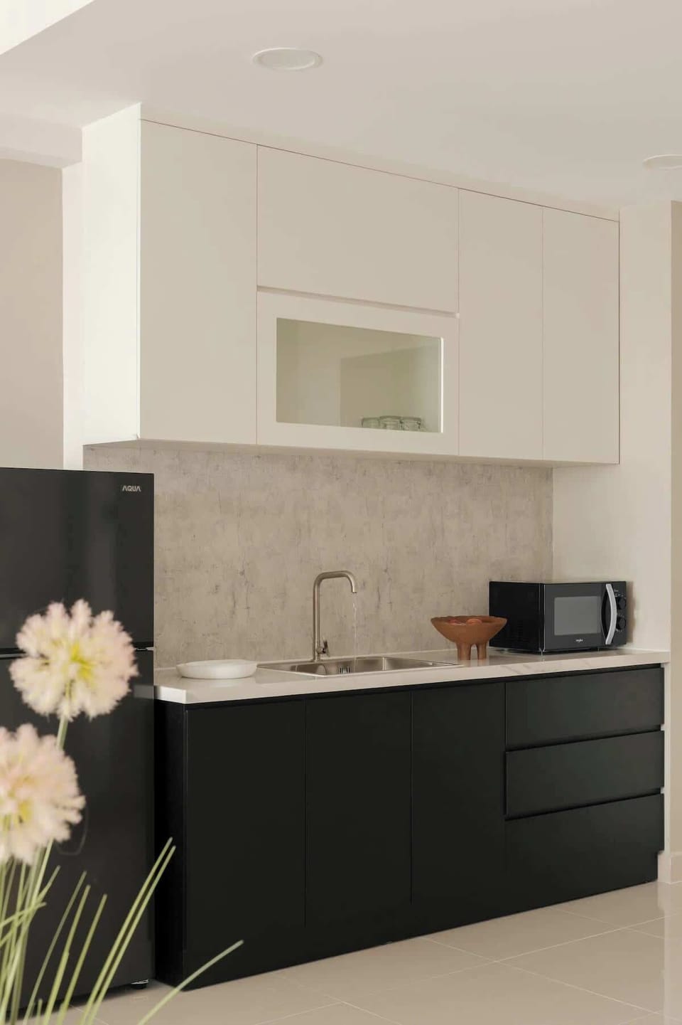 Sleek kitchen equipped with fridge freezer, microwave and all the essentials including cookware, plates, bowls, glasses and more. Great for light cooking, preparing snacks or enjoying a chilled bottle of wine.