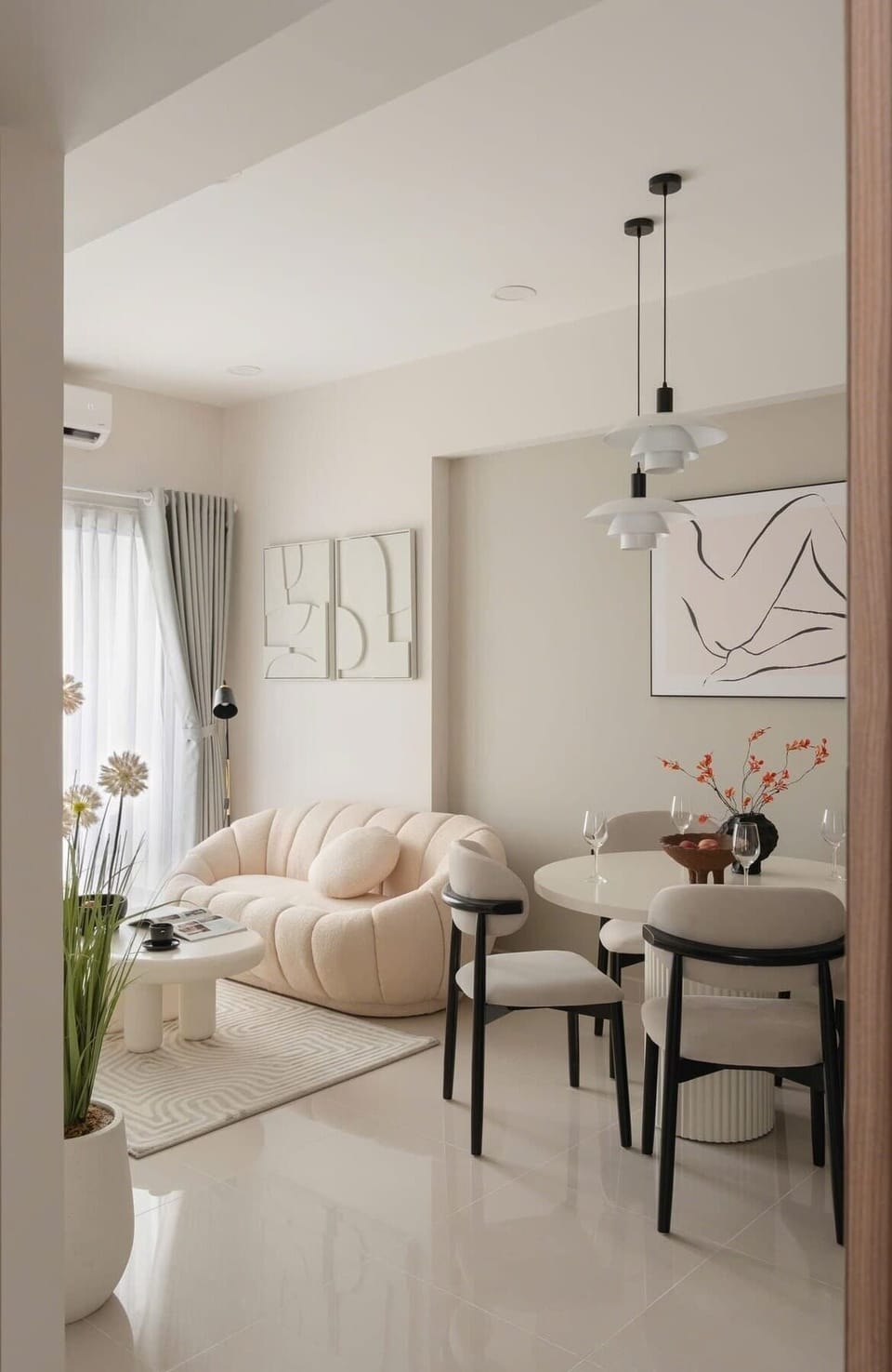 Stylish living space with a unique rounded sofa and modern wall art. A cozy spot for relaxing, bathed in natural light from the balcony. Great for quiet reading or enjoying a morning coffee.