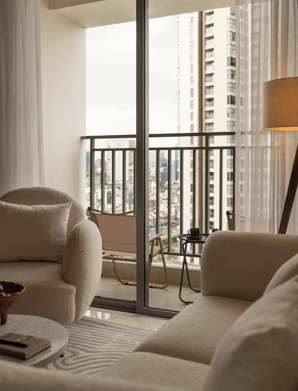 View of the outside balcony which features a gorgeous city and lake view with two comfortable seats perfect for relaxation with a morning coffee or tea.