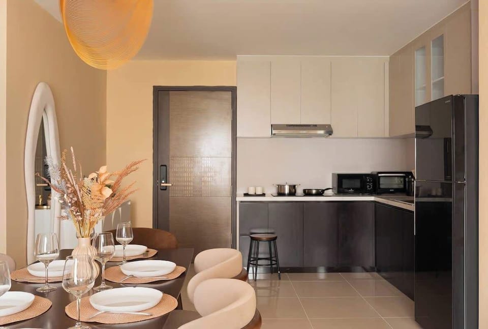 Enjoy a sleek kitchen with stovetop, microwave, fridge, wine & beer glasses, coffee mugs, utensils, cookware, and glassware. Includes complimentary bottled water and G7 Vietnamese coffee for every guest.