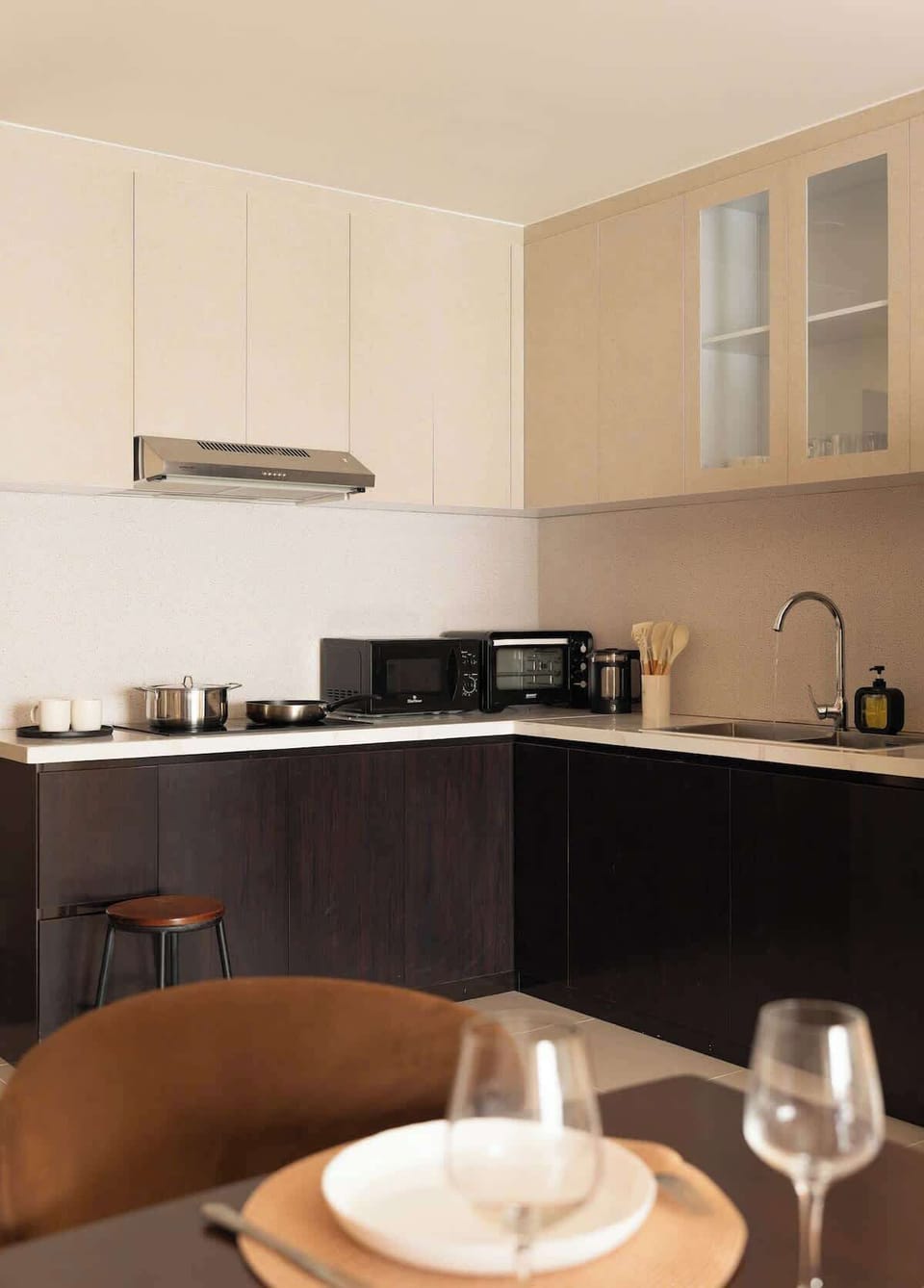 Enjoy a sleek kitchen with stovetop, microwave, fridge, wine & beer glasses, coffee mugs, premium utensils, cookware, and glassware. Includes complimentary bottled water and G7 Vietnamese coffee for every guest.