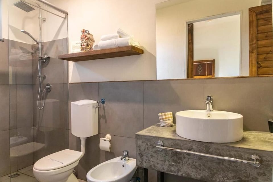 Standard Quadruple Room, Patio, Garden View | Bathroom | Shower, rainfall showerhead, free toiletries, hair dryer