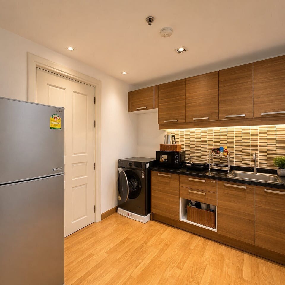 Modern kitchen with in-unit washer and sleek wood finishes