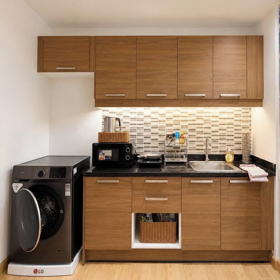 Modern kitchenette with washer, sleek storage, and practical amenities