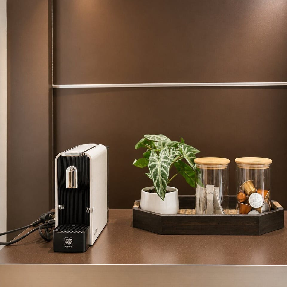 Stylish in-room coffee station with espresso machine and curated amenities