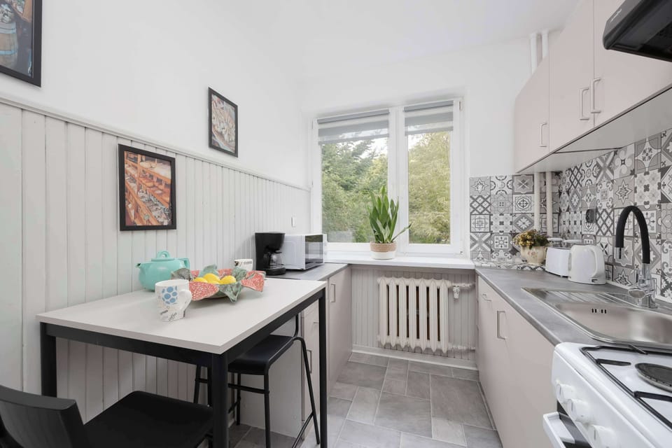 Functional kitchen with a dining table, modern appliances, and plenty of natural light.