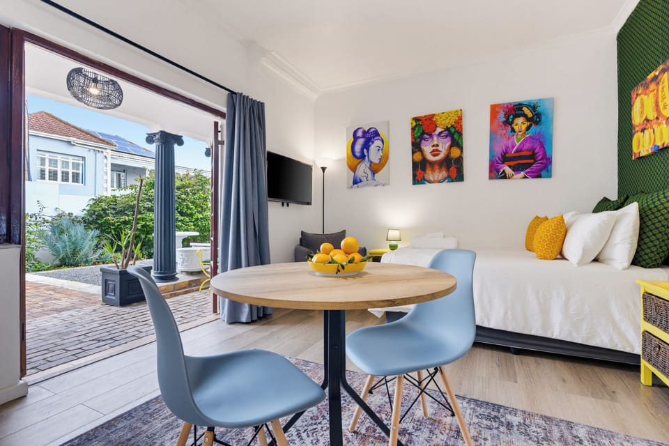 Bright, art-filled studio with patio access and a cozy dining nook