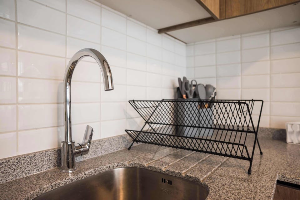 Modern kitchen with sleek chrome fixtures and ample counter space, perfect for cooking and dining in comfort.