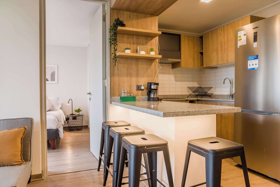 Stylish kitchen with modern amenities and cozy seating, perfect for enjoying meals and relaxation.