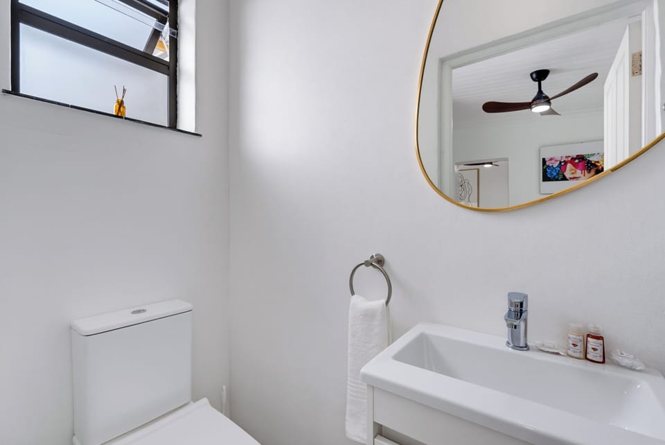 Bright modern bathroom with stylish mirror and natural light