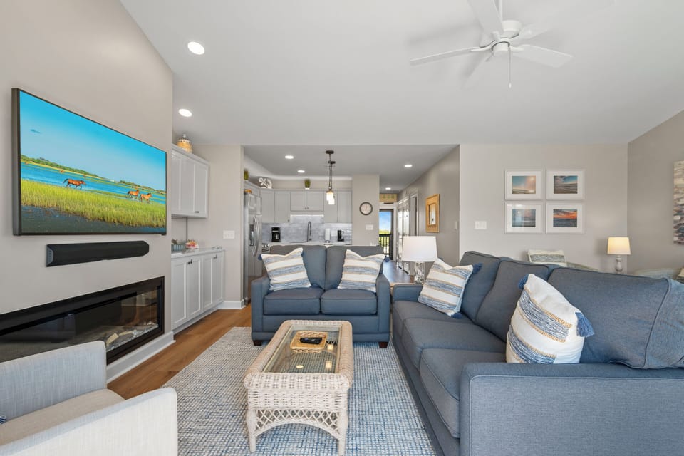 Sink into your plush sectional and enjoy coastal tranquility with the fireplace crackling and ceiling fan keeping you cool.