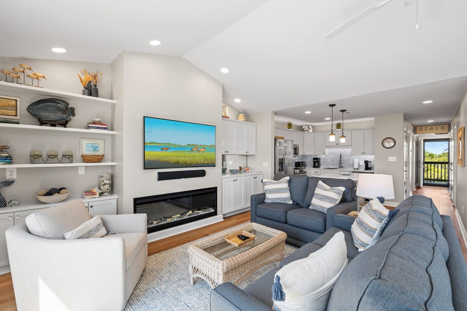 Settle into your elegant open-concept retreat with plush seating, warming fireplace, and modern kitchen - perfect for memorable gatherings.