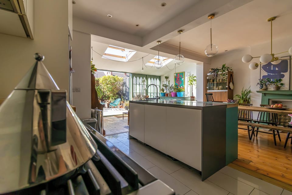 Sun-filled designer kitchen with island, skylights, and patio access