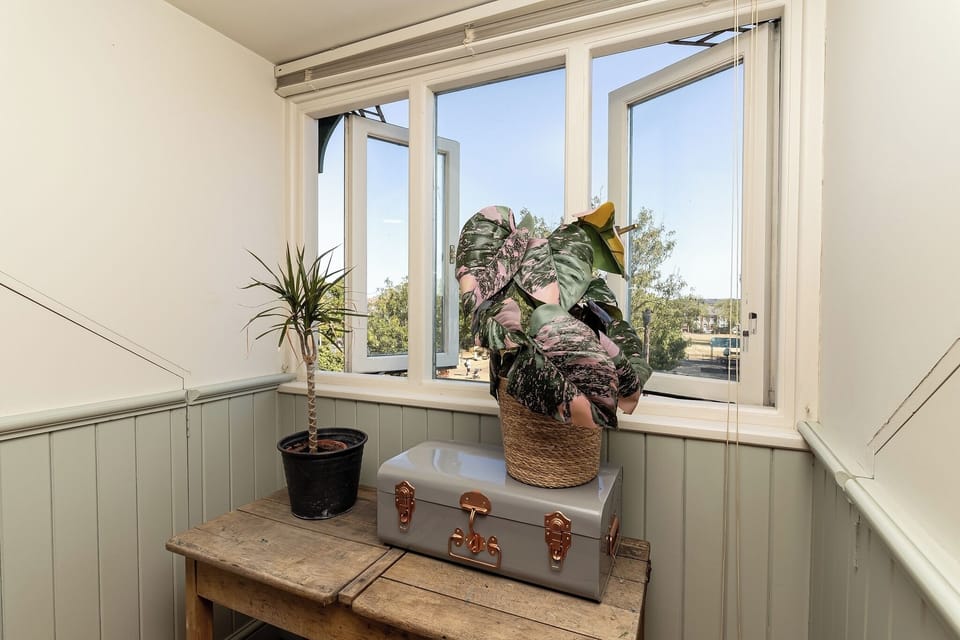 Sunny window nook with fresh air, natural light, and charming decor