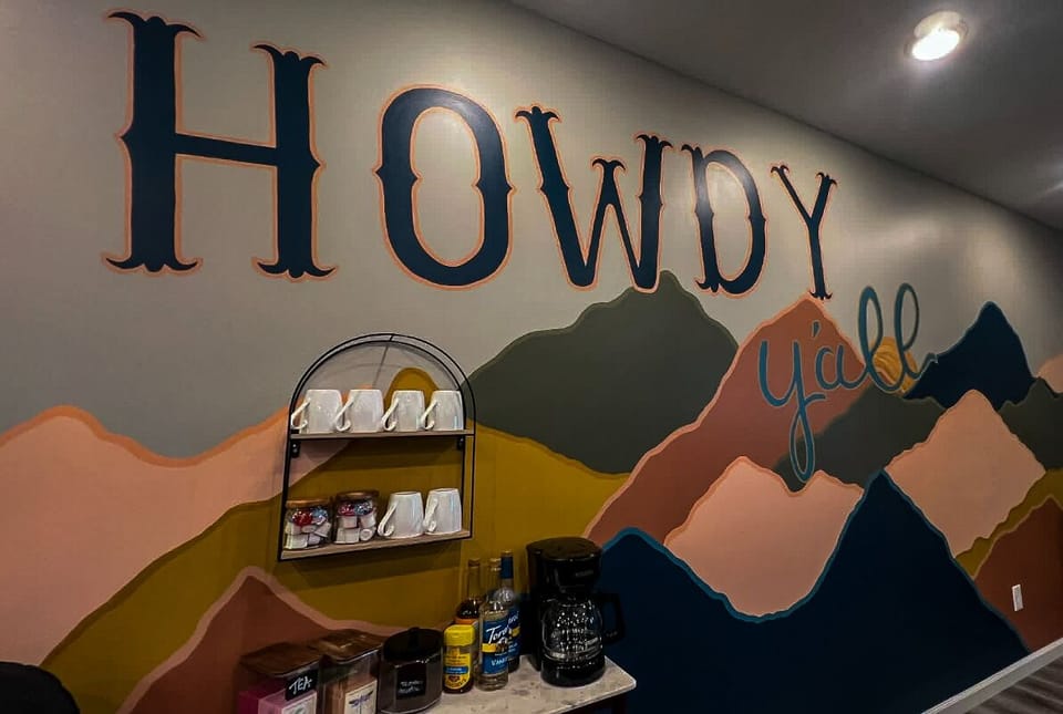 The property welcomes guests with distinctive signage and a warm mountain mural, setting the stage for your alpine getaway.